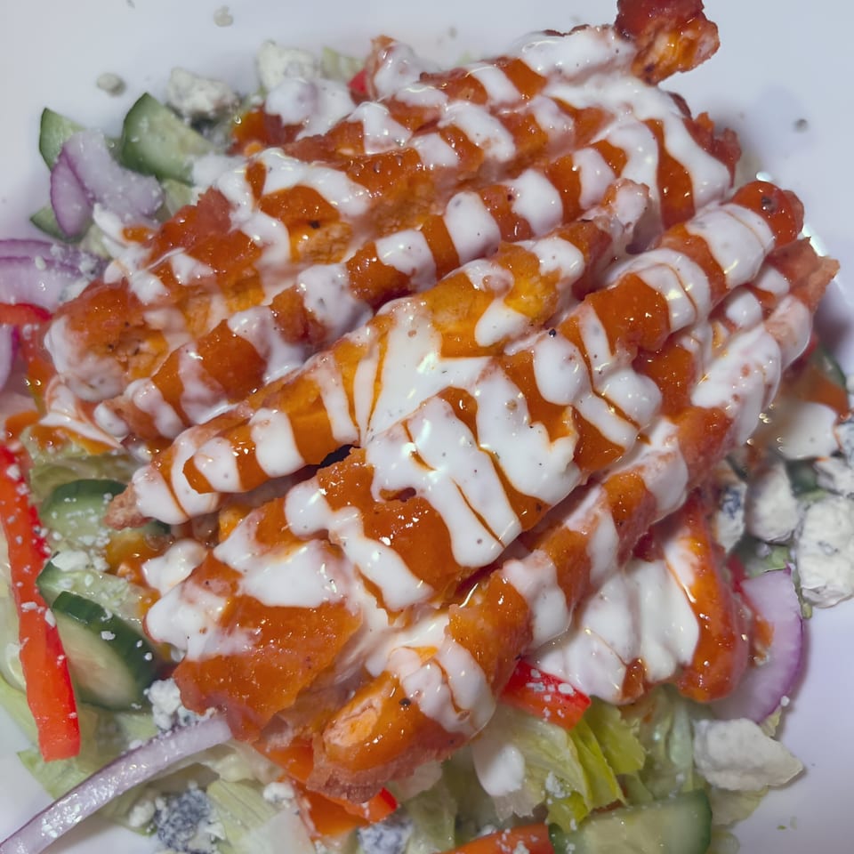 Southwood Bar's buffalo chicken salad with blue cheese crumbles, red onion, cucumber, and ranch dressing.